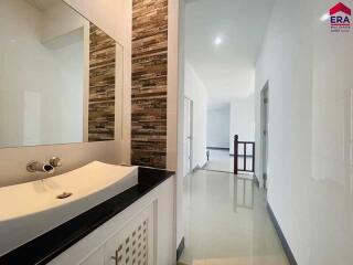 Modern bathroom with a sink and hallway view