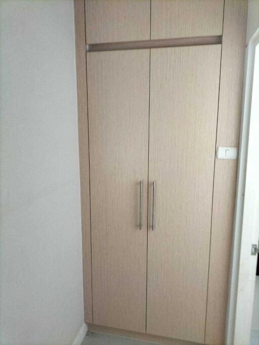 Bedroom closet with wooden doors