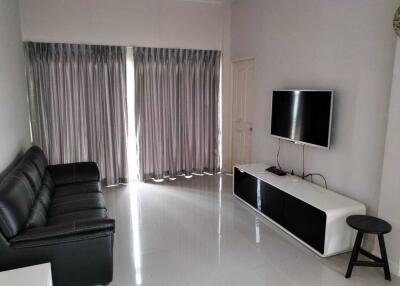 Modern living room with curtains and a mounted TV