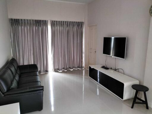 Modern living room with curtains and a mounted TV