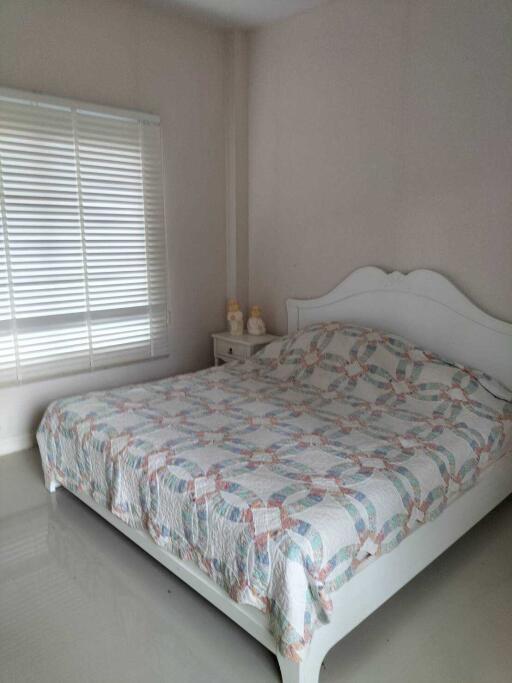 Bedroom with a double bed and window with blinds