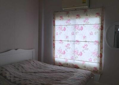 Cozy bedroom with floral curtains and a white bed