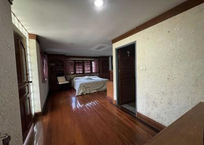 Bedroom with wooden flooring, double bed, and wardrobe