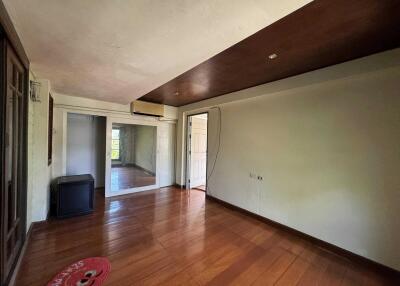 Spacious living room with wooden flooring and large glass doors