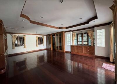 Spacious living room with wooden floors and large windows