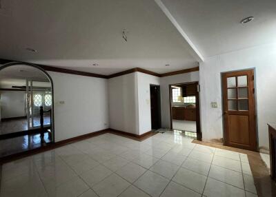 Spacious living area with tiles and wood accents