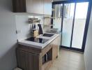 Modern kitchen with wooden cabinetry and large window