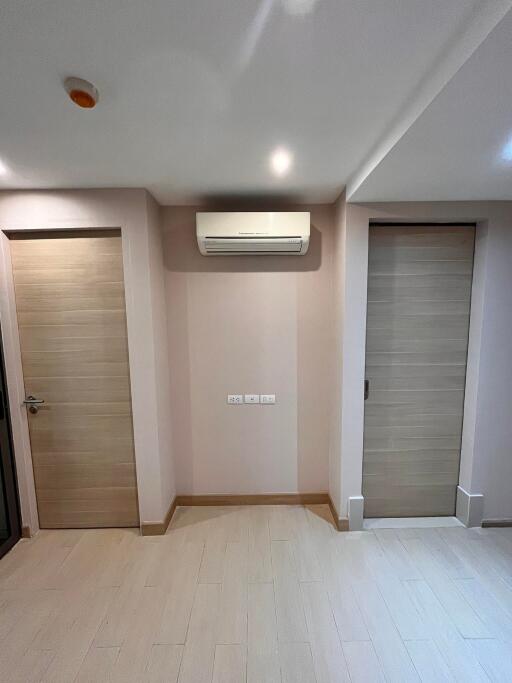 A room with two wooden doors and an air conditioner