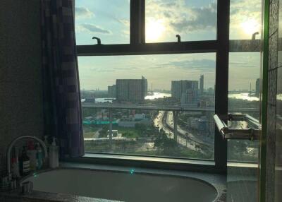 Bathroom with a large window offering city view