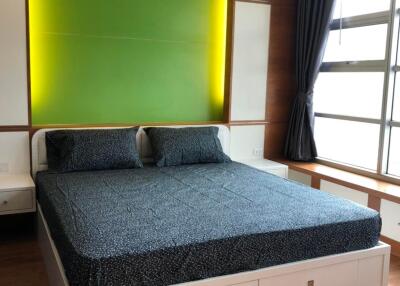 Modern bedroom with green accent wall