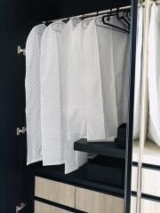 Spacious walk-in closet with hanging garment covers