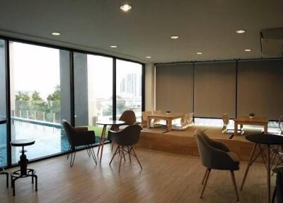 Modern living area with large windows and pool view