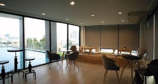 Modern living area with large windows and pool view