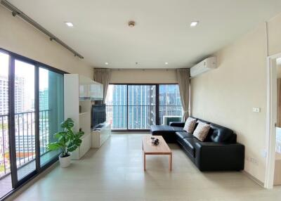 Modern living room with floor-to-ceiling windows and city view