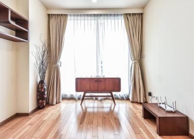 Minimalist living room with wooden furniture and large window