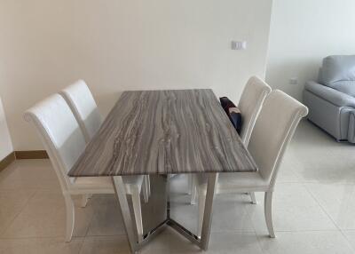 Modern dining area with a marble-top table and white chairs