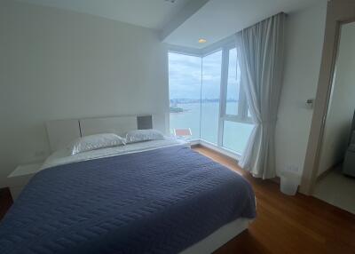 Bedroom with large window and water view