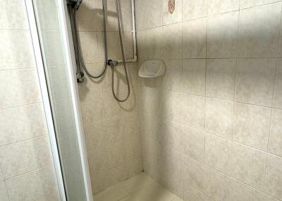 Shower area with water heater and sliding door