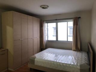 Bedroom with large wardrobe and window