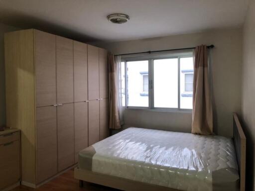 Bedroom with large wardrobe and window