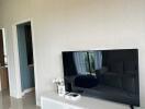 Modern living room with TV and white console unit