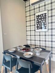 Modern dining area with table setting and artwork