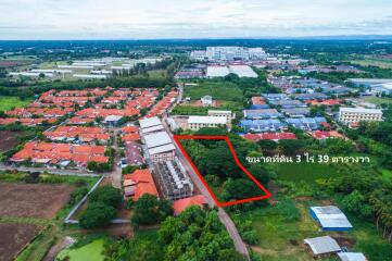 Aerial view of residential area with land plot marked