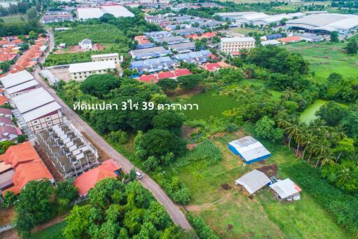 Aerial view of a housing development area with text in Thai language