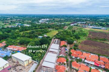 Aerial view of a residential area with surrounding greenery