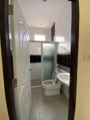 Bathroom with a sliding glass shower door, toilet, and sink