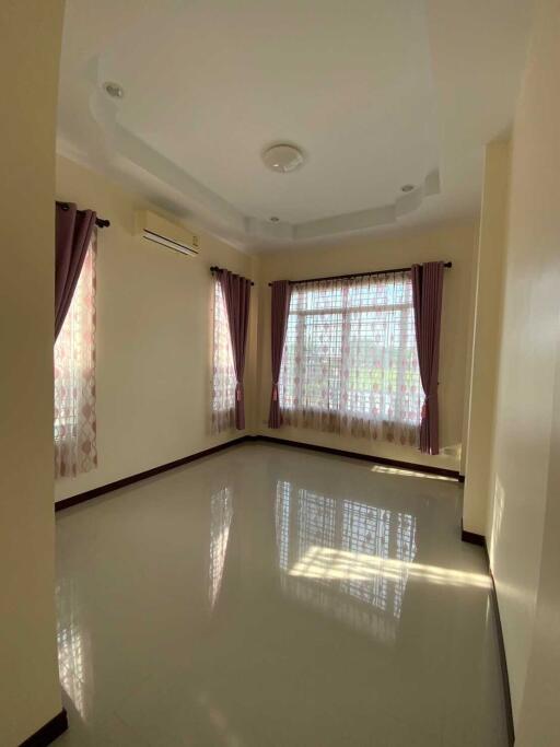 Living room with large windows and curtains