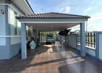 Covered carport area with vehicle parked