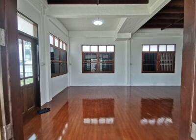 Spacious living room with wooden floor and large windows