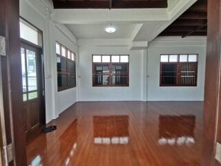 Spacious living room with wooden floor and large windows