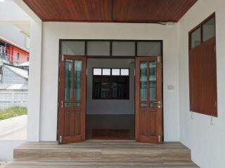 Front entrance with wooden double doors