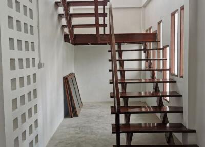 Modern staircase with wooden steps and white walls