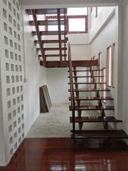 Modern staircase with wooden steps and white walls