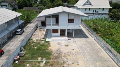 Two-story house with surrounding yard and driveway