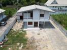 Two-story house with surrounding yard and driveway