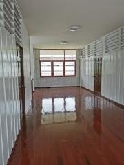 Spacious hallway with wooden floor and large window