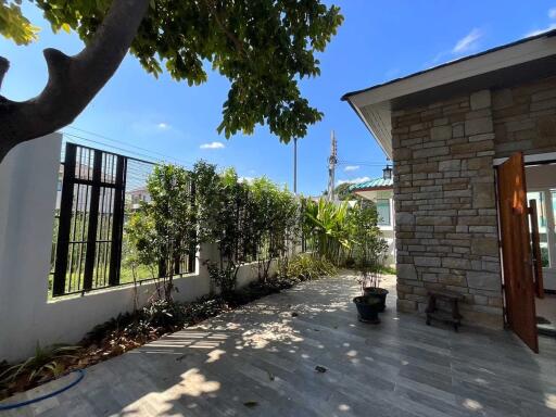 Outdoor courtyard with garden and stone wall