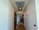 Well-lit hallway with wooden flooring