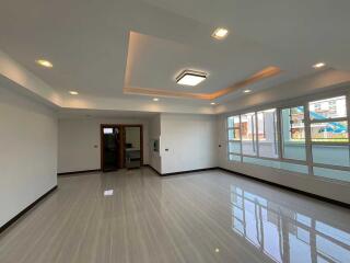 Spacious modern living room with large windows and recessed lighting