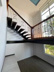 Modern staircase with wooden and metal railing