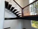 Modern staircase with wooden and metal railing