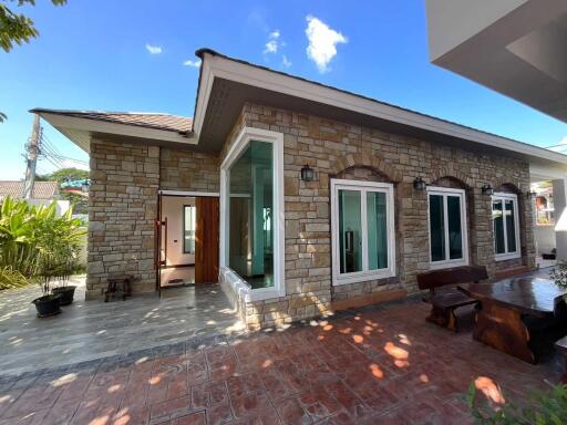 Exterior view of a modern house with stone facade and large windows