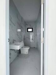 Modern bathroom with marble tiled walls and floor