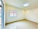 bright empty living room with white walls and tiled flooring