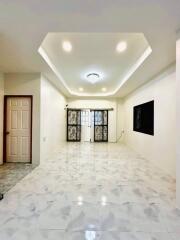 Modern living room with recessed lighting and marble flooring