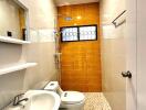 Modern bathroom with white sink, toilet, and shower